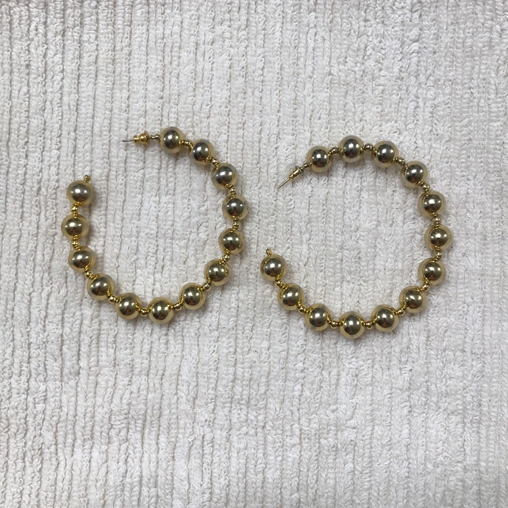 Large gold tone ball earrings.